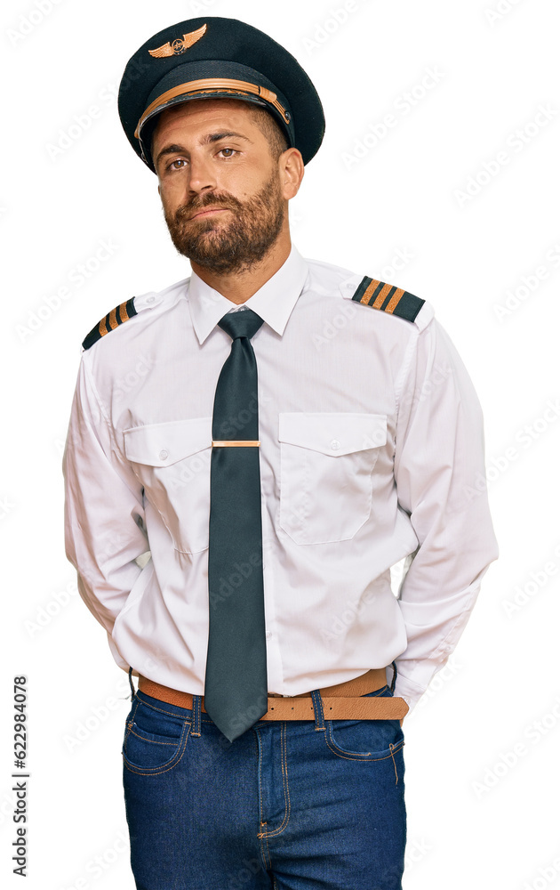 Handsome man with beard wearing airplane pilot uniform depressed and worry for distress, crying angry and afraid. sad expression. Handsome man with beard wearing airplane pilot uniform depressed and worry for distress, crying angry and afraid. sad expression.