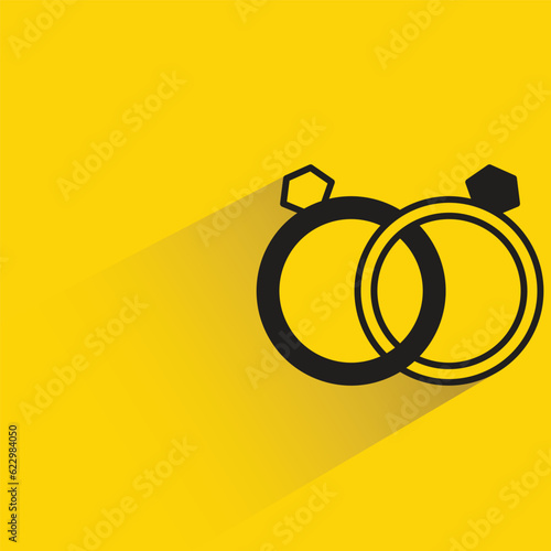 couple of rings with shadow on yellow background