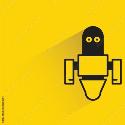 robot with shadow on yellow background