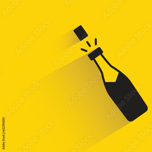 champaign bottle with shadow on yellow background
