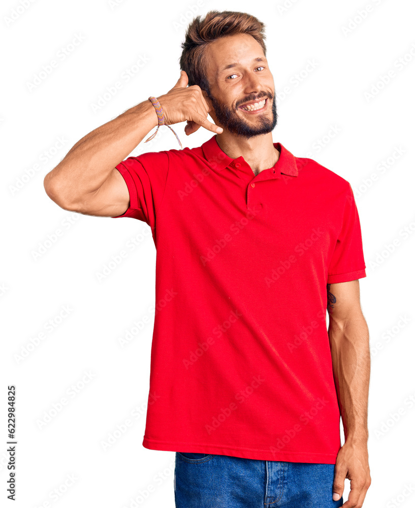 Handsome blond man with beard wearing casual clothes smiling doing phone gesture with hand and fingers like talking on the telephone. communicating concepts. Handsome blond man with beard wearing casual clothes smiling doing phone gesture with hand and fingers like talking on the telephone. communicating concepts.