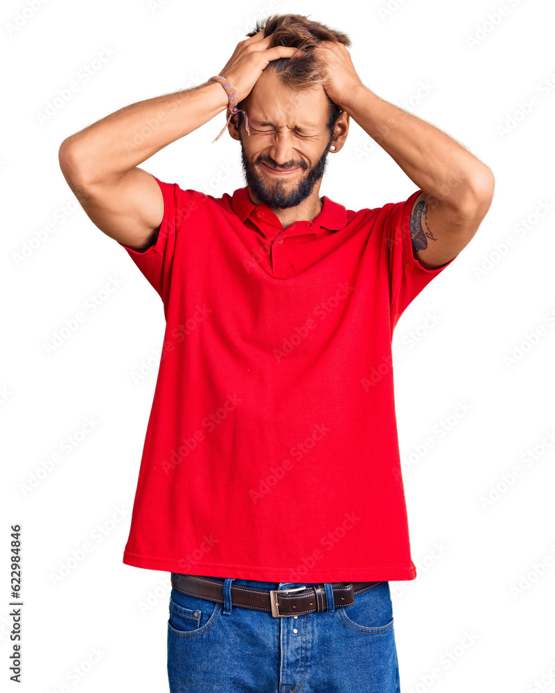 Handsome blond man with beard wearing casual clothes suffering from headache desperate and stressed because pain and migraine. hands on head. Handsome blond man with beard wearing casual clothes suffering from headache desperate and stressed because pain and migraine. hands on head.