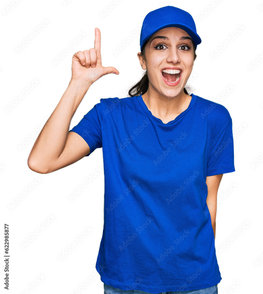 Young hispanic girl wearing delivery courier uniform pointing finger up with successful idea. exited and happy. number one. Young hispanic girl wearing delivery courier uniform pointing finger up with successful idea. exited and happy. number one.