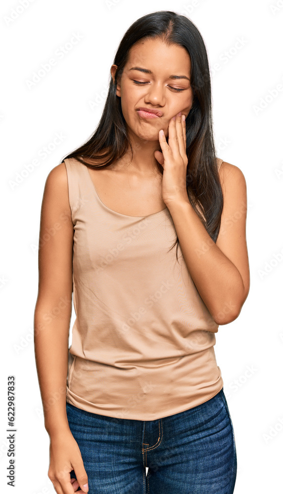 Beautiful hispanic woman wearing casual clothes touching mouth with hand with painful expression because of toothache or dental illness on teeth. dentist Beautiful hispanic woman wearing casual clothes touching mouth with hand with painful expression because of toothache or dental illness on teeth. dentist