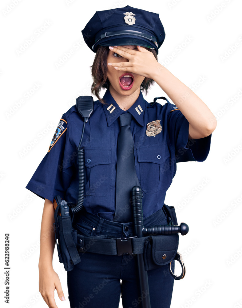 Young beautiful girl wearing police uniform peeking in shock covering face and eyes with hand, looking through fingers with embarrassed expression. Young beautiful girl wearing police uniform peeking in shock covering face and eyes with hand, looking through fingers with embarrassed expression.