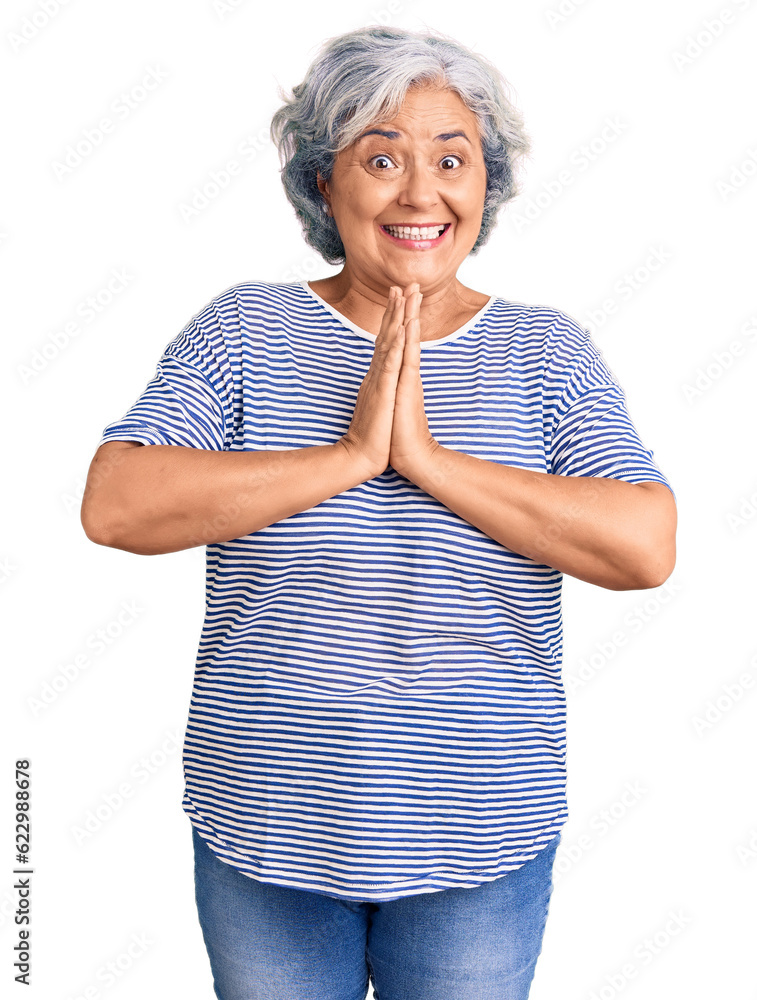Senior woman with gray hair wearing casual striped clothes praying with hands together asking for forgiveness smiling confident. Senior woman with gray hair wearing casual striped clothes praying with hands together asking for forgiveness smiling confident.