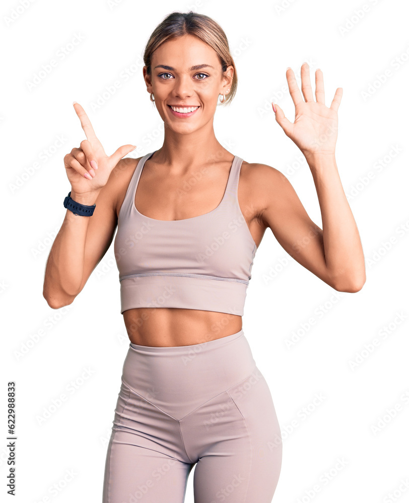 Beautiful caucasian woman wearing sportswear showing and pointing up with fingers number seven while smiling confident and happy. Beautiful caucasian woman wearing sportswear showing and pointing up with fingers number seven while smiling confident and happy.