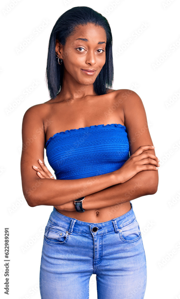 Young african american woman wearing casual summer clothes happy face smiling with crossed arms looking at the camera. positive person. Young african american woman wearing casual summer clothes happy face smiling with crossed arms looking at the camera. positive person.