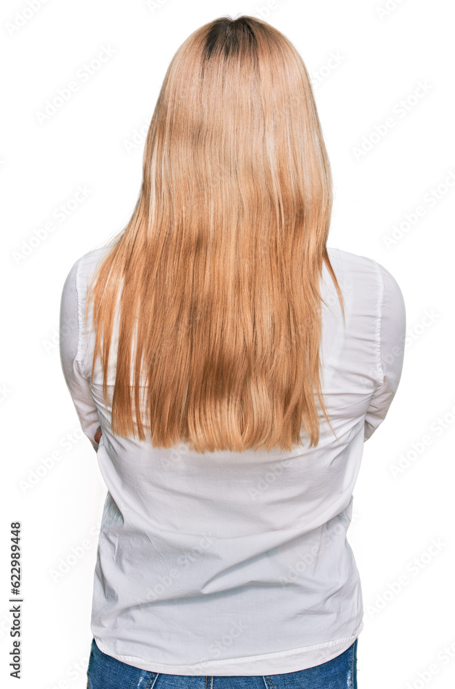 Naklejka premium Young caucasian woman wearing casual clothes standing backwards looking away with crossed arms