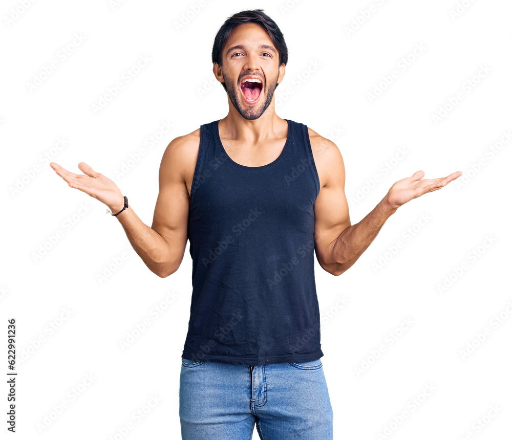 Handsome hispanic man wearing casual clothes celebrating victory with happy smile and winner expression with raised hands Handsome hispanic man wearing casual clothes celebrating victory with happy smile and winner expression with raised hands