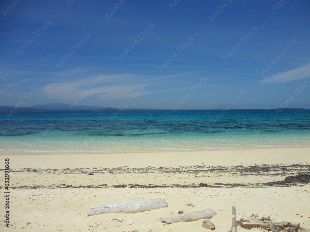 Beautiful White Sand Beach Located in North Maluku, Indonesia. Beautiful Scenery of Blue Sky, Ocean and White Sand Beach.