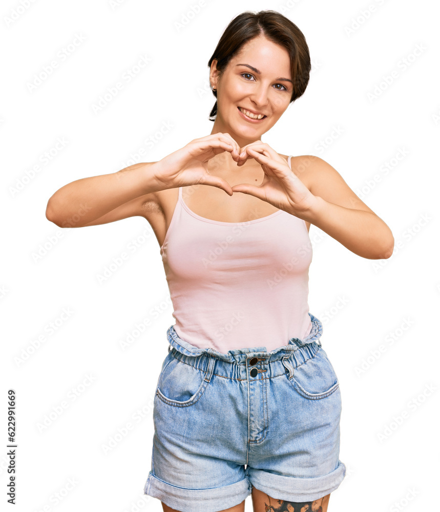 Young brunette woman with short hair wearing casual summer clothes smiling in love showing heart symbol and shape with hands. romantic concept. Young brunette woman with short hair wearing casual summer clothes smiling in love showing heart symbol and shape with hands. romantic concept.