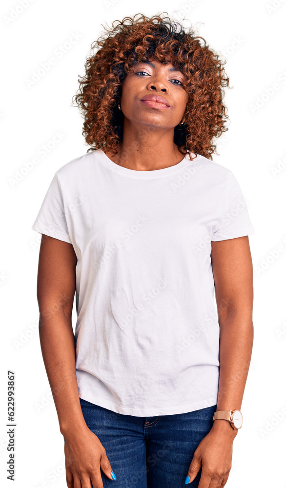 Young african american woman wearing casual white tshirt relaxed with serious expression on face. simple and natural looking at the camera. Young african american woman wearing casual white tshirt relaxed with serious expression on face. simple and natural looking at the camera.