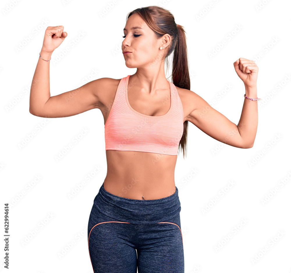 Young beautiful hispanic woman wearing sportswear showing arms muscles smiling proud. fitness concept. Young beautiful hispanic woman wearing sportswear showing arms muscles smiling proud. fitness concept.