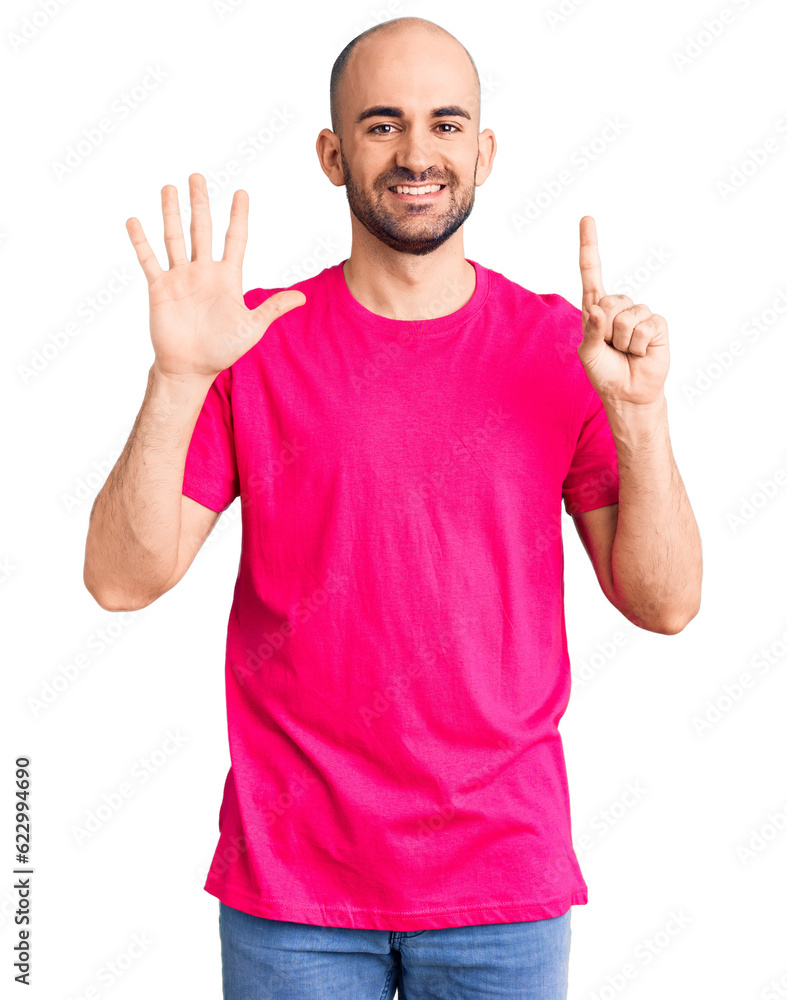 Young handsome man wearing casual t shirt showing and pointing up with fingers number six while smiling confident and happy. Young handsome man wearing casual t shirt showing and pointing up with fingers number six while smiling confident and happy.