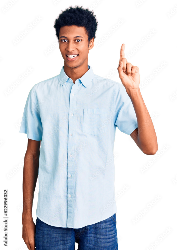 Young african american man wearing casual clothes pointing finger up with successful idea. exited and happy. number one. Young african american man wearing casual clothes pointing finger up with successful idea. exited and happy. number one.
