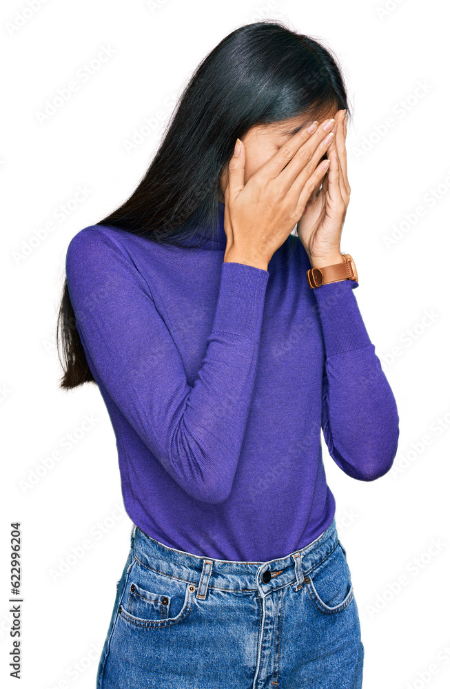 Beautiful young asian woman wearing casual clothes with sad expression covering face with hands while crying. depression concept. Beautiful young asian woman wearing casual clothes with sad expression covering face with hands while crying. depression concept.