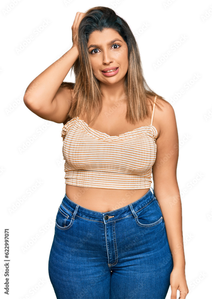 Fototapeta premium Beautiful brunette woman wearing casual clothes confuse and wonder about question. uncertain with doubt, thinking with hand on head. pensive concept.