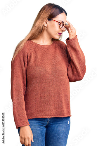 Beautiful young woman wearing casual clothes and glasses tired rubbing nose and eyes feeling fatigue and headache. stress and frustration concept.