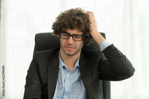 Business, people and office concept. Stressed businessman while working at workplace in office