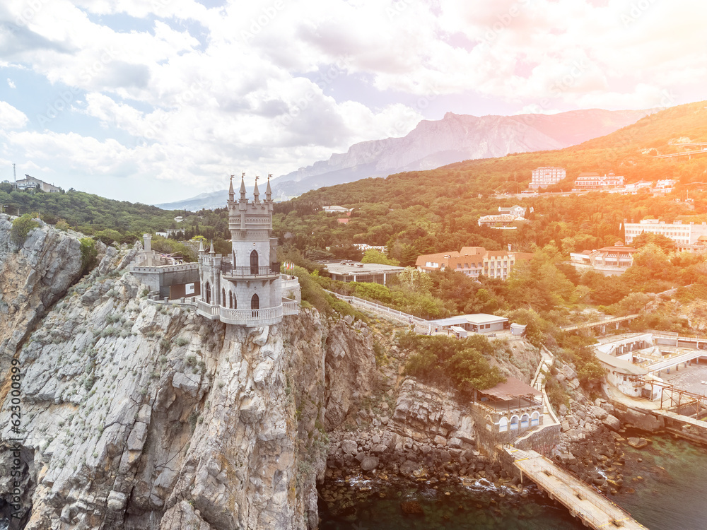 Fototapeta premium Crimea Swallow's Nest Castle on the rock over the Black Sea. It is a tourist attraction of Crimea. Amazing aerial view of the Crimea coast with the castle above abyss on sunny day.