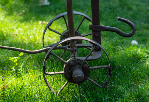 iron rusty cart in grass photo