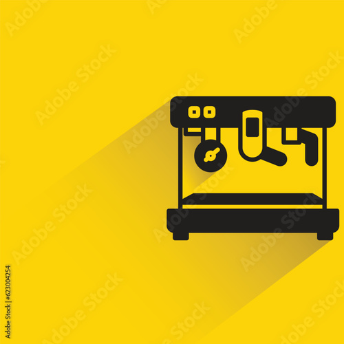 coffee machine with shadow on yellow background