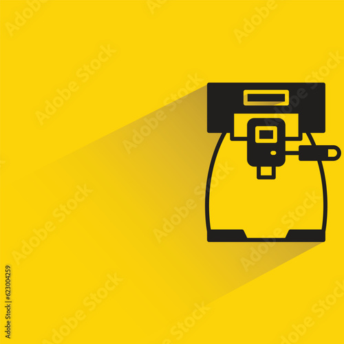 coffee machine with shadow on yellow background