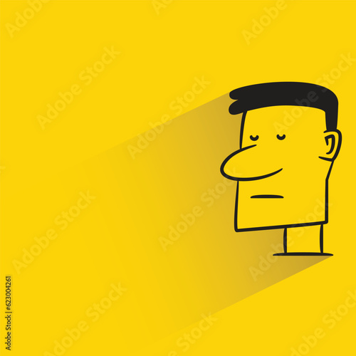 male face with shadow on yellow background