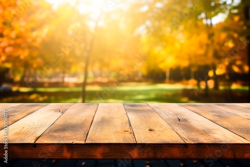 Wooden table with orange fall leaves. Autumn background with copy space. Selective focus and bokeh effect.