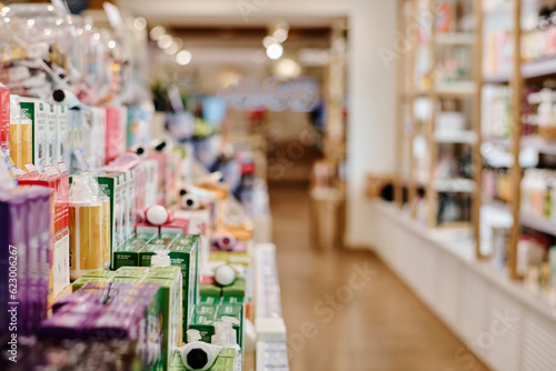 Close-up of products standing on shelves in a row in cosmetics department in shopping mall