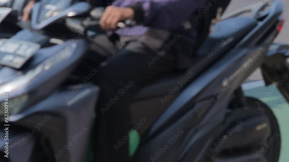 Many motorcycles and cars travel on paved roads in urban areas during the day. Depicts the density of urban traffic. Shot with a telephoto lens and handheld, the shot is quite close up. Many motorcycles and cars travel on paved roads in urban areas during the day. Depicts the density of urban traffic. Shot with a telephoto lens and handheld, the shot is quite close up.