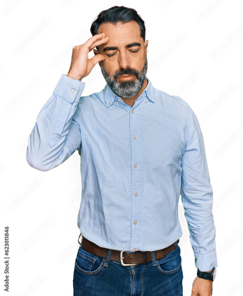 Middle aged man with beard wearing business shirt worried and stressed about a problem with hand on forehead, nervous and anxious for crisis Middle aged man with beard wearing business shirt worried and stressed about a problem with hand on forehead, nervous and anxious for crisis