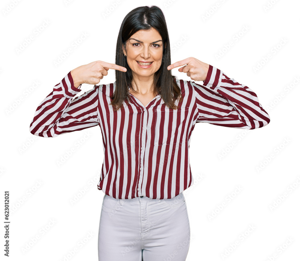 Beautiful brunette woman wearing striped shirt smiling cheerful showing and pointing with fingers teeth and mouth. dental health concept. Beautiful brunette woman wearing striped shirt smiling cheerful showing and pointing with fingers teeth and mouth. dental health concept.