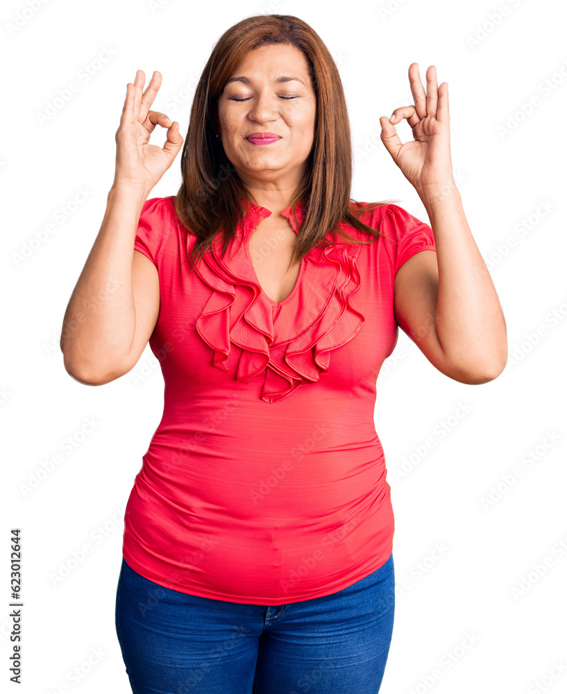 Middle age latin woman wearing casual clothes relax and smiling with eyes closed doing meditation gesture with fingers. yoga concept. Middle age latin woman wearing casual clothes relax and smiling with eyes closed doing meditation gesture with fingers. yoga concept.