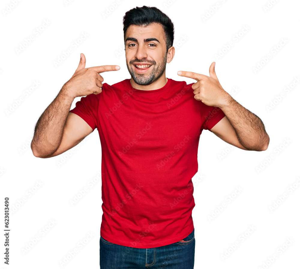 Hispanic man with beard wearing casual red t shirt smiling cheerful showing and pointing with fingers teeth and mouth. dental health concept. Hispanic man with beard wearing casual red t shirt smiling cheerful showing and pointing with fingers teeth and mouth. dental health concept.