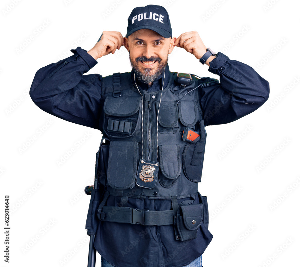 Young handsome man wearing police uniform smiling pulling ears with fingers, funny gesture. audition problem Young handsome man wearing police uniform smiling pulling ears with fingers, funny gesture. audition problem