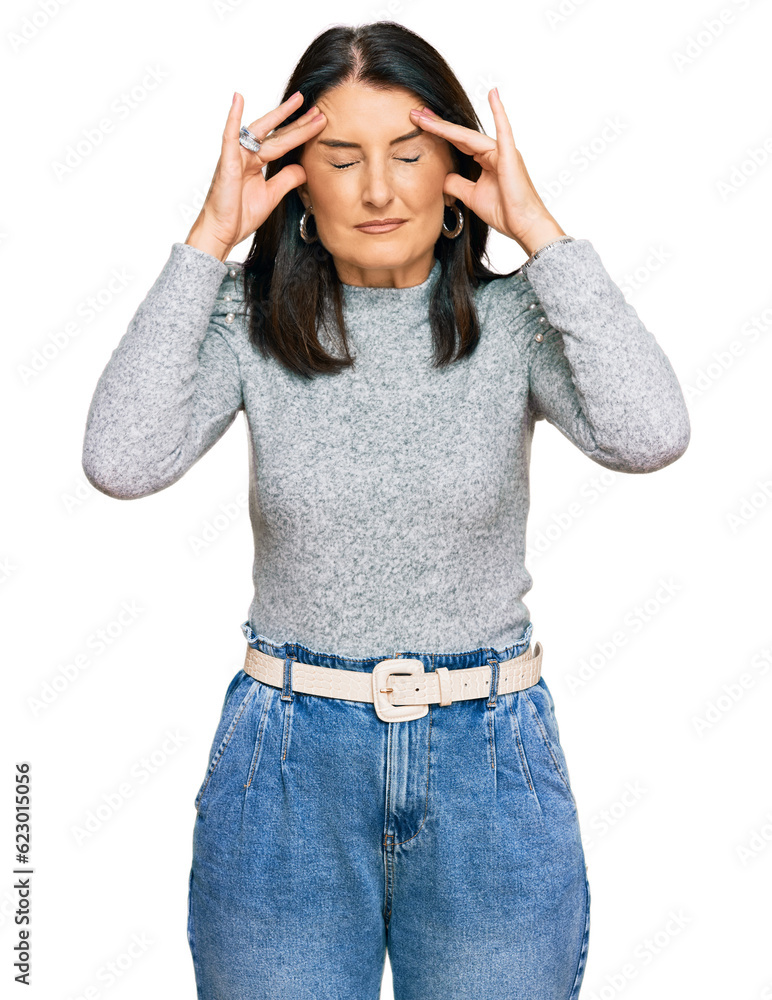 Middle age brunette woman wearing casual clothes with hand on head for pain in head because stress. suffering migraine. Middle age brunette woman wearing casual clothes with hand on head for pain in head because stress. suffering migraine.
