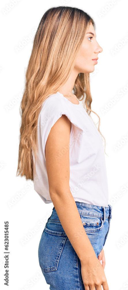 Beautiful caucasian woman with blonde hair wearing casual white tshirt looking to side, relax profile pose with natural face with confident smile. Beautiful caucasian woman with blonde hair wearing casual white tshirt looking to side, relax profile pose with natural face with confident smile.