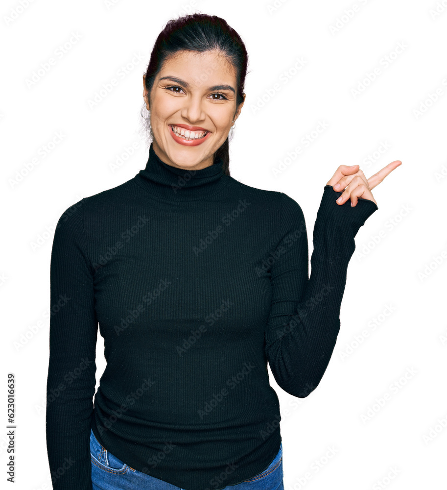 Young hispanic woman wearing casual clothes with a big smile on face, pointing with hand and finger to the side looking at the camera. Young hispanic woman wearing casual clothes with a big smile on face, pointing with hand and finger to the side looking at the camera.