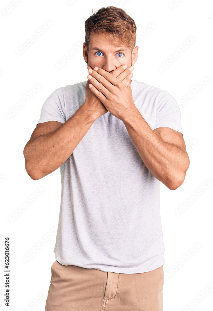 Young caucasian man wearing casual white tshirt shocked covering mouth with hands for mistake. secret concept. Young caucasian man wearing casual white tshirt shocked covering mouth with hands for mistake. secret concept.