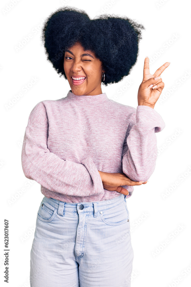 Young african american girl wearing casual clothes smiling with happy face winking at the camera doing victory sign. number two. Young african american girl wearing casual clothes smiling with happy face winking at the camera doing victory sign. number two.