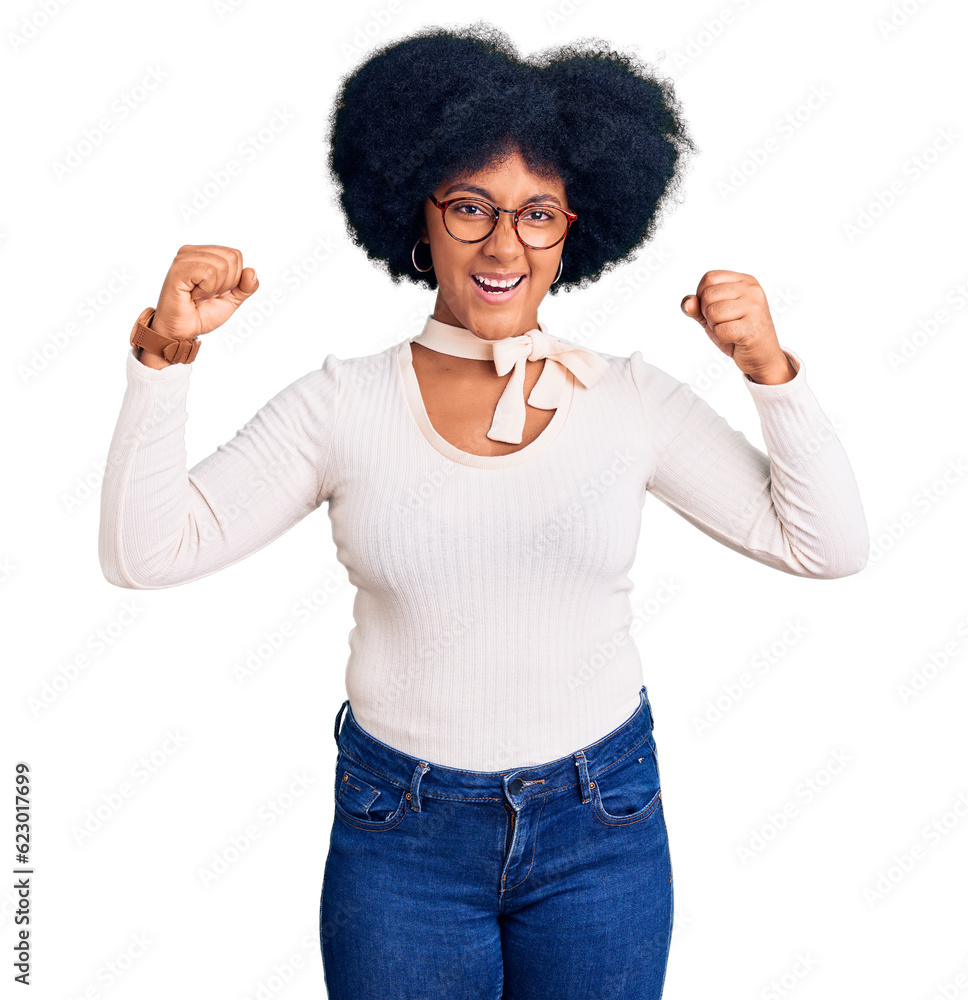 Young african american girl wearing casual clothes and glasses angry and mad raising fists frustrated and furious while shouting with anger. rage and aggressive concept. Young african american girl wearing casual clothes and glasses angry and mad raising fists frustrated and furious while shouting with anger. rage and aggressive concept.