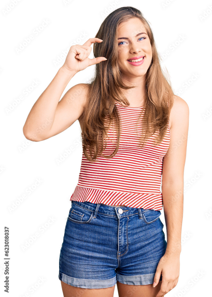 Beautiful caucasian young woman wearing casual clothes smiling and confident gesturing with hand doing small size sign with fingers looking and the camera. measure concept. Beautiful caucasian young woman wearing casual clothes smiling and confident gesturing with hand doing small size sign with fingers looking and the camera. measure concept.