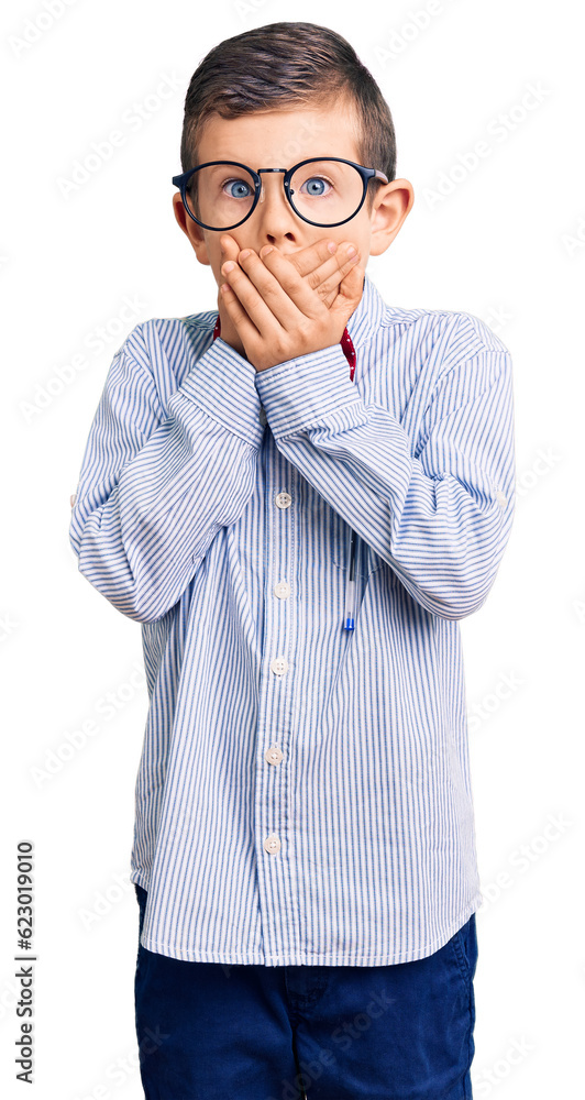 Cute blond kid wearing nerd bow tie and glasses shocked covering mouth with hands for mistake. secret concept. Cute blond kid wearing nerd bow tie and glasses shocked covering mouth with hands for mistake. secret concept.