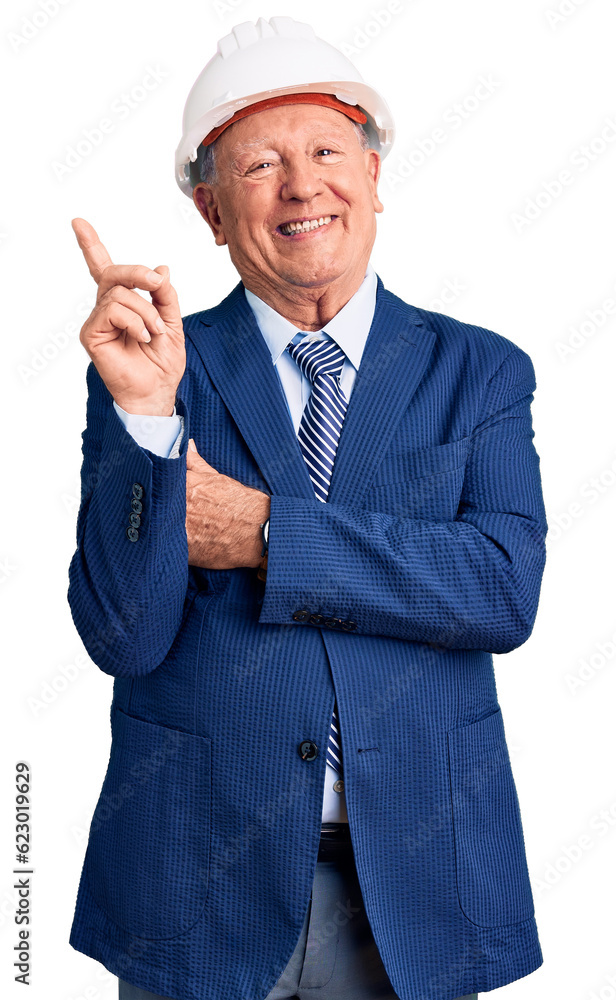 Senior handsome grey-haired man wearing suit and architect hardhat with a big smile on face, pointing with hand and finger to the side looking at the camera. Senior handsome grey-haired man wearing suit and architect hardhat with a big smile on face, pointing with hand and finger to the side looking at the camera.