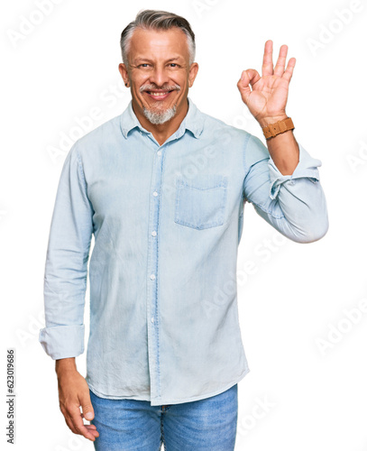 Middle age grey-haired man wearing casual clothes smiling positive doing ok sign with hand and fingers. successful expression.