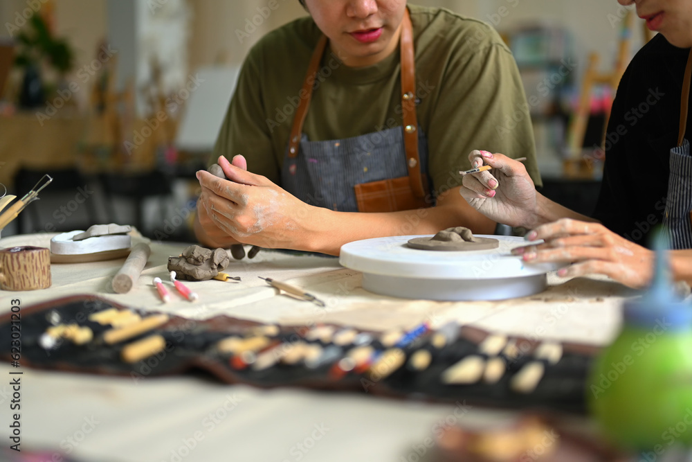 Man modeling clay in pottery creative activity, handicraft
