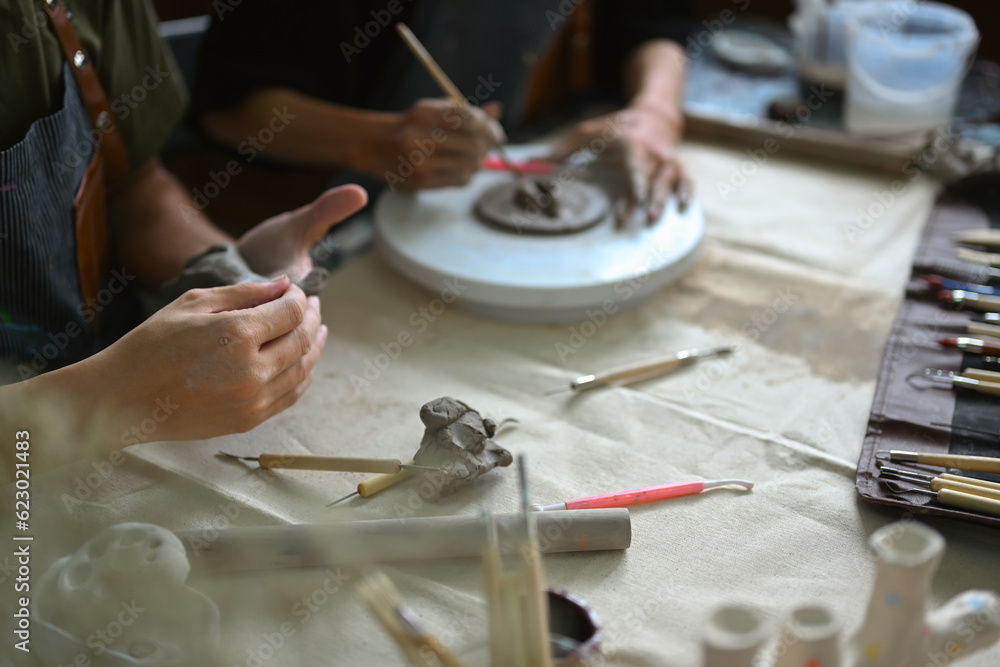 Obraz premium Two young men friends are enjoying creative process, creating handmade ceramics in workshop