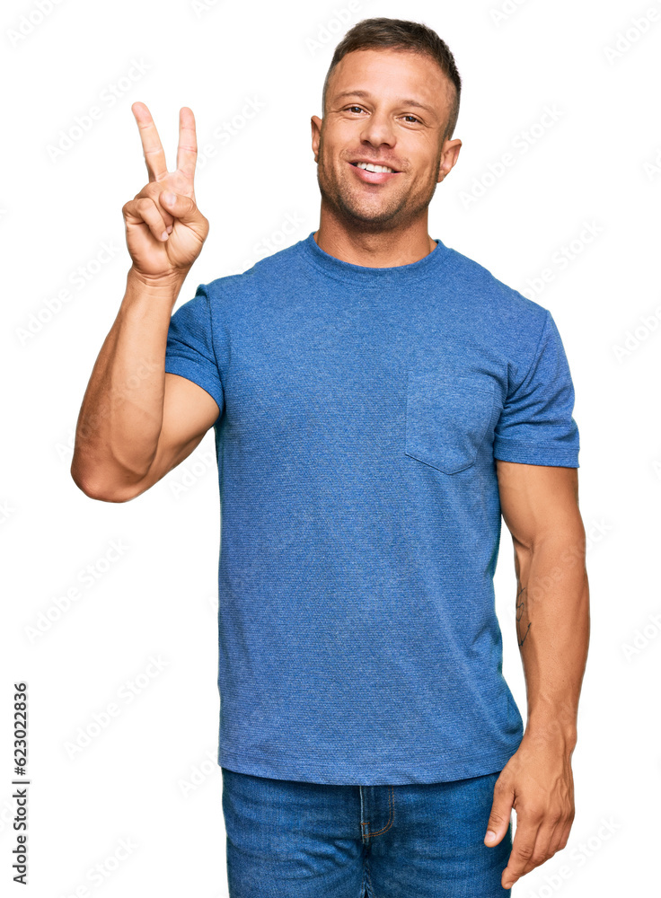 Handsome muscle man wearing casual clothes showing and pointing up with fingers number two while smiling confident and happy. Handsome muscle man wearing casual clothes showing and pointing up with fingers number two while smiling confident and happy.